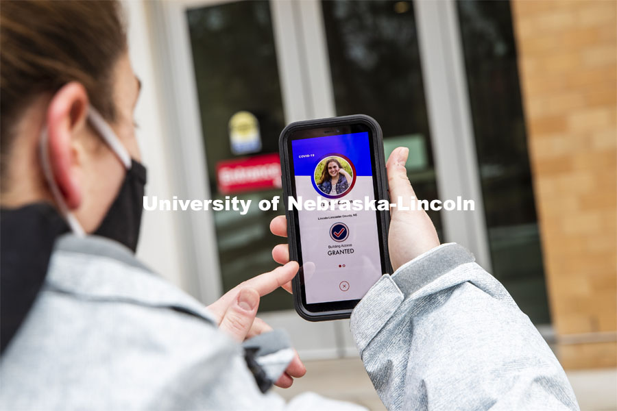 Taylor Daum shows the Safer Community app to be used as part of COVID testing on campus this spring. Phone screen is simulated and may change slightly in the final rollout. January 8, 2021. Photo by Craig Chandler / University Communication.
