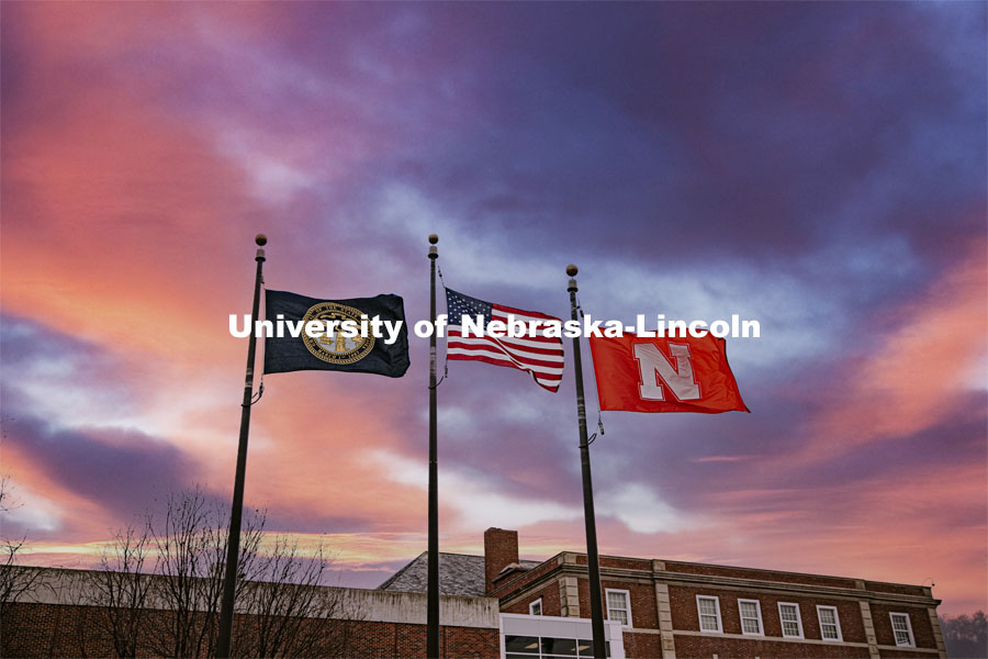 High winds whip the flags between Canfield Hall and the Nebraska Union. January 14, 2021. Photo by Craig Chandler / University Communication.