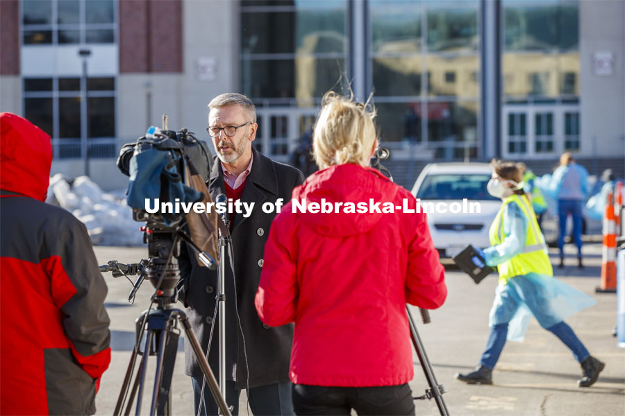 Chancellor Ronnie Green talks with media and takes his COVID-19 saliva test Tuesday afternoon at the East Stadium loop site.  January 19, 2021. Photo by Craig Chandler / University Communication