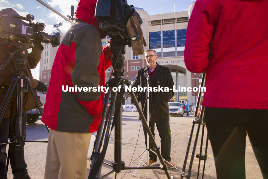 Chancellor Ronnie Green talks with media and takes his COVID-19 saliva test Tuesday afternoon at the East Stadium loop site.  January 19, 2021. Photo by Craig Chandler / University Communication