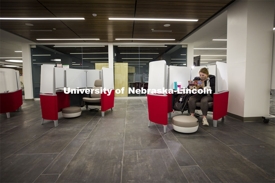 Taylor Ruwe, a freshman from Hooper, NE, studies in a pod similar to a first-class airline seat in the lower level of the Dinsdale Family Learning Commons on East Campus. January 28, 2021. Photo by Craig Chandler / University Communication.