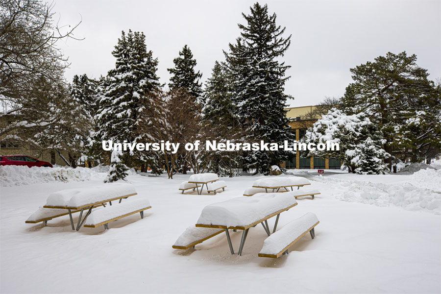 The picnic tables outside of the Nebraska East Union on East Campus are covered in more than 14” of snow from the snowstorm on Monday. January 28, 2021. Photo by Craig Chandler / University Communication.