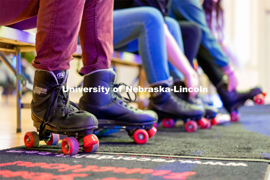 Students put on their pair of rollerblades before skating during the Club 80 Roller Skating Event in the Nebraska Union Ballroom on Friday, February 19, 2021, in Lincoln, Nebraska. Photo by Jordan Opp for University Communication.