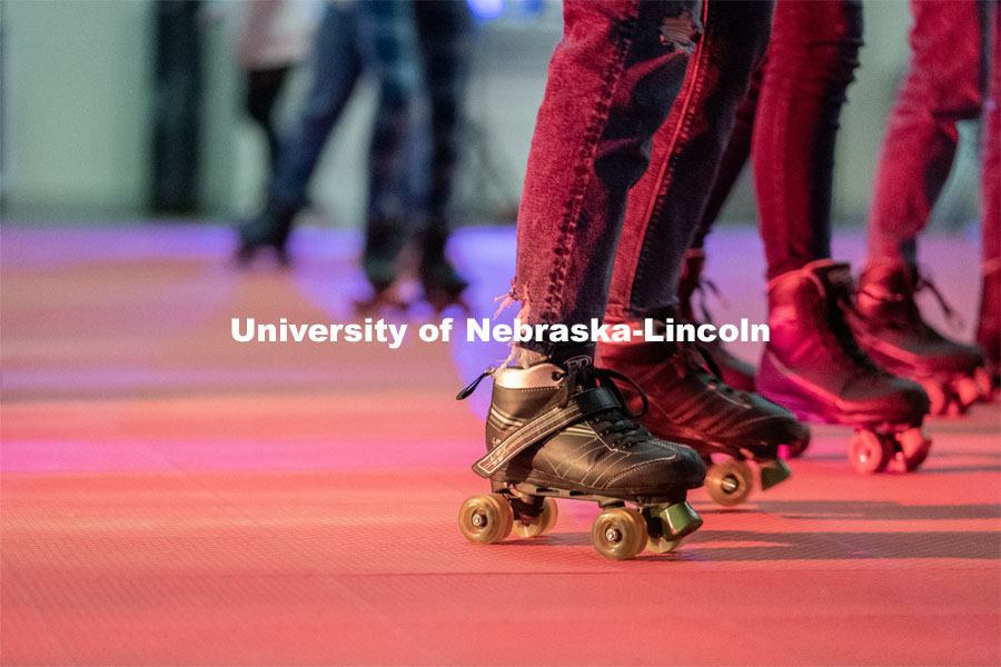 Students skate in a circle during the Club 80 Roller Skating Event in the Nebraska Union Ballroom on Friday, February 19, 2021, in Lincoln, Nebraska. Photo by Jordan Opp for University Communication.