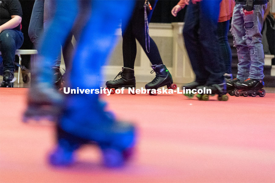 Students skate in a circle during the Club 80 Roller Skating Event in the Nebraska Union Ballroom on Friday, February 19, 2021, in Lincoln, Nebraska. Photo by Jordan Opp for University Communication.