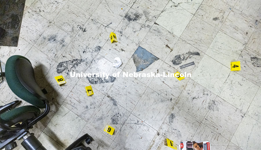 Evidence markers and a ruler are placed next to footprints being collected as evidence. Forensic Science 485 is the capstone for the seniors. The CSI option students work a mock crime scene while the biochemistry option students process the samples. The class concludes with a mock trial. March 2, 2021. Photo by Craig Chandler / University Communication.