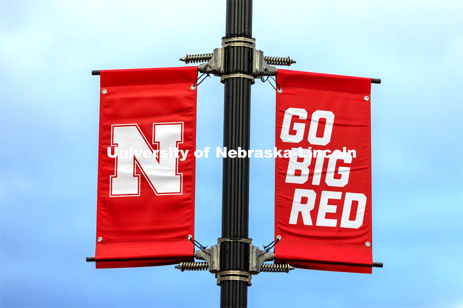 New banners are going up around campus. The N150 banners are being replaced by ones with our N and Go Big Red, alternating with In Our Grit Our Glory. March 25, 2021. Photo by Craig Chandler / University Communication.