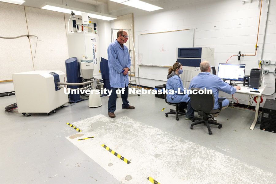 Pat Dussault, Michelle Takacs and Dan Draney look over results from the Research Instrumentation Facility’s high-field NMR (nuclear magnetic resonance) spectrometer in Hamilton Hall. April 6, 2021. Photo by Craig Chandler / University Communication.