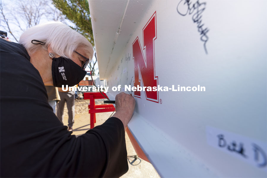 Marjorie Kostelnik, professor for Child, Youth, and Family Studies at CEHS, adds her signature to the final beam. Topping out ceremony for the new construction atop the demolished Mabel Lee Hall. April 9, 2021. Photo by Craig Chandler / University Communication.
