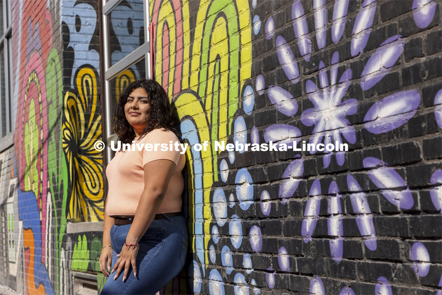 Josselyn Catalan, junior in global studies and ethnic studies, poses by a mural in an alleyway of the Haymarket for an ASEM recruiting story. April 13, 2021. Photo by Craig Chandler / University Communication.  