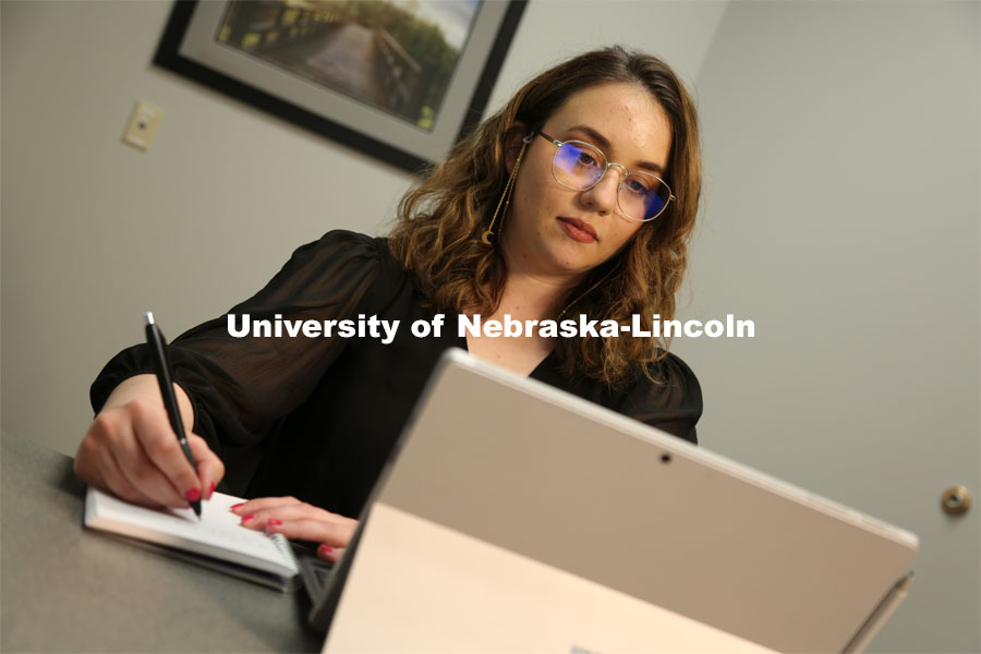 Brenna Lash, a graduate student in the Clinical Psychology Training Program, loads the telehealth platform on her laptop, as seen from an observation room, where clinic faculty supervisors monitor sessions. April 13, 2021. Photo by David Fitzgibbon / University Communication.  
