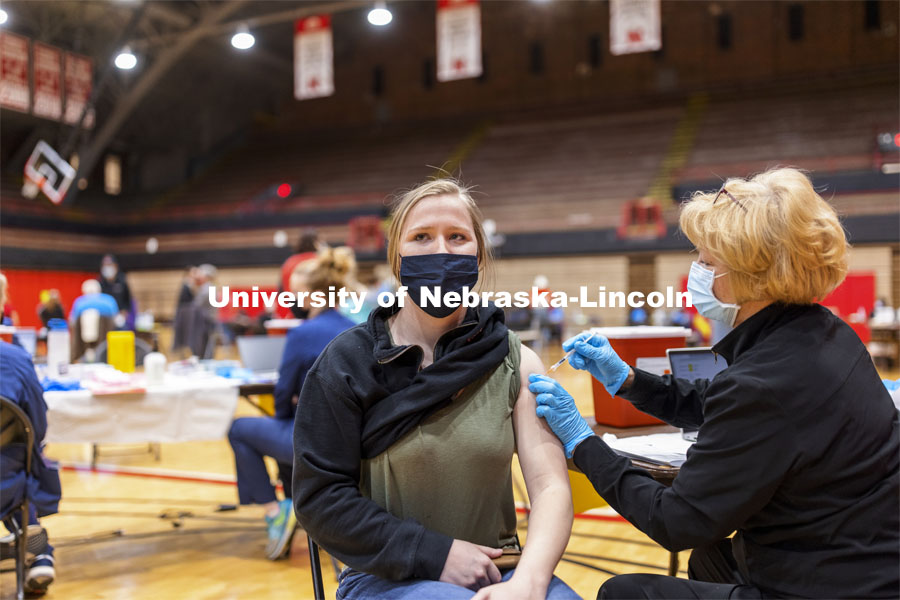 Whitney Steckel receives her first dose of vaccine during a COVID-19 vaccination clinic April 20 at the Coliseum. Vaccine clinic in the Coliseum with a free food and goodies tent outside. April 20, 2021. Photo by Craig Chandler / University Communication.