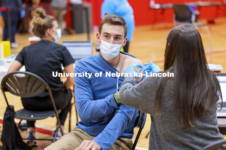 Dayton Mays receives his first dose of vaccine during a COVID-19 vaccination clinic April 20 at the Coliseum. Vaccine clinic in the Coliseum with a free food and goodies tent outside. April 20, 2021. Photo by Craig Chandler / University Communication.