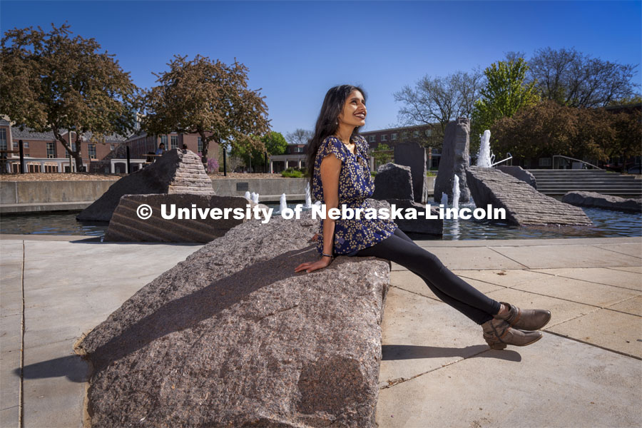 Riha Karney, a Speech-Language Pathologist major, is pictured sitting by the Broyhill fountain outside of the City Union for an ASEM recruiting story. April 29, 2021. Photo by Craig Chandler / University Communication.  