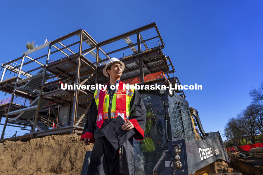 Yajyoo Shrestha, a graduating senior in civil engineering, stands before the construction site of the new College of Education and Human Sciences building on City Campus. April 29, 2021. Photo by Craig Chandler / University Communication.  