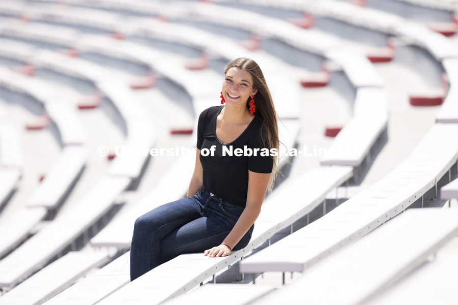 Erika Swenson, a Fisheries and Wildlife major, is pictured sitting in Memorial Stadium an ASEM recruitment feature story. April 30, 2021. Photo by Craig Chandler / University Communication.  