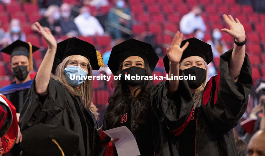 Professor Stacie Ray and audiology doctoral students Manami Shah and Emma Wilken wave to family and friends before the ceremony. Graduate Commencement at Pinnacle Bank Arena. May 7, 2021. Photo by Craig Chandler / University Communication.