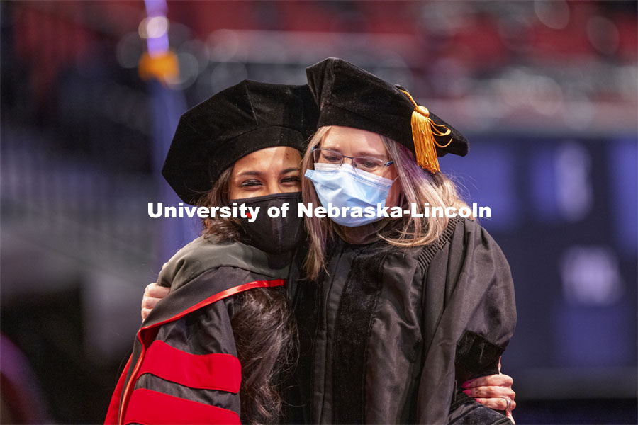 Manami Shah is hugged by Professor Stacie Ray. Shah received her Doctor of Audiology degree. Graduate Commencement at Pinnacle Bank Arena. May 7, 2021. Photo by Craig Chandler / University Communication.