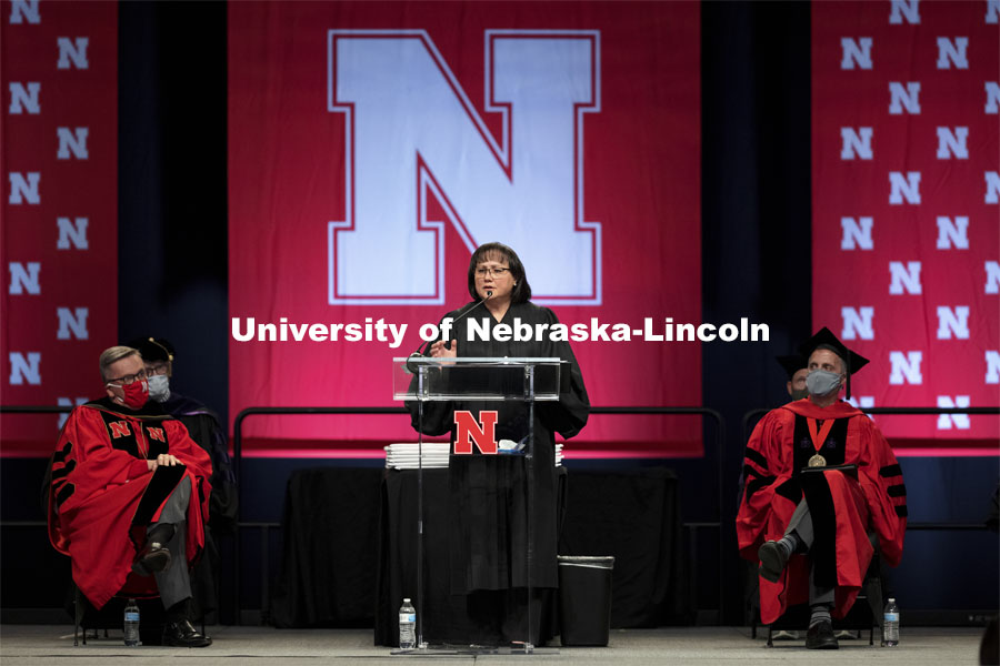 Hon. Riko Bishop, Judge, Nebraska Court of Appeals and a 1992 Nebraska Law graduate, gives the commencement address as UNL Chancellor Ronnie Green and Dean Richard Moberly listen.  College of Law Graduation at Pinnacle Bank Arena. May 7, 2021. Photo by Craig Chandler / University Communication.