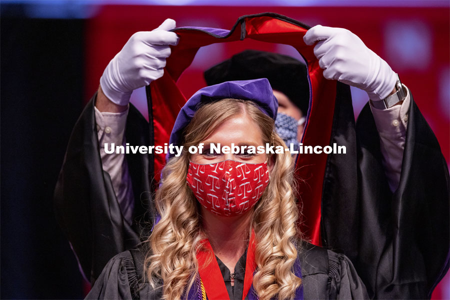 Allison Seiler sports a legal mask as she is hooded. College of Law Graduation at Pinnacle Bank Arena. May 7, 2021. Photo by Craig Chandler / University Communication.