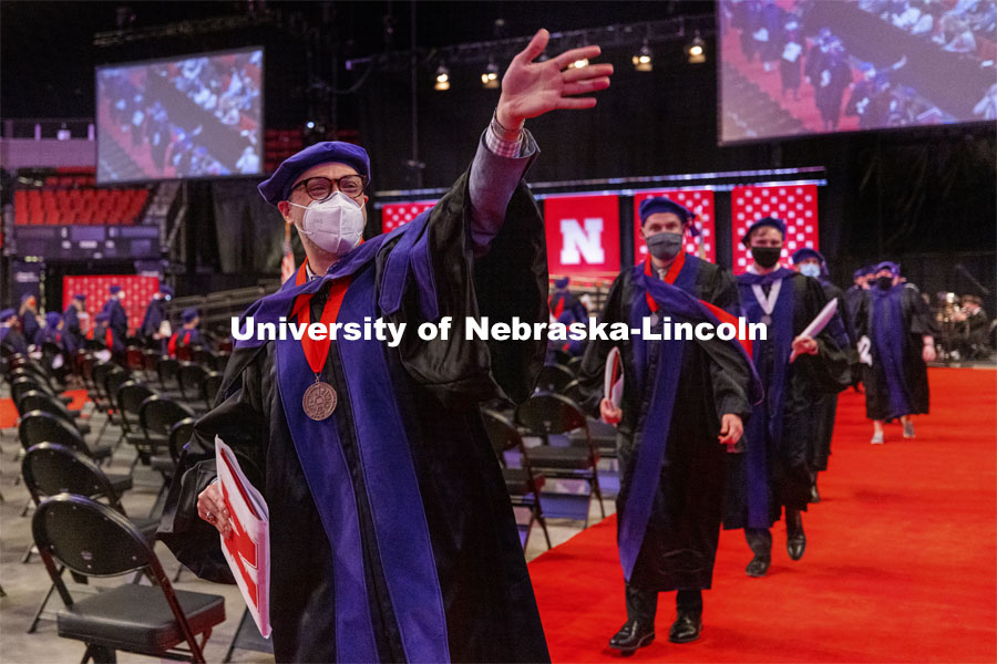 Curtis Fuller waves to family and friends as the graduates process out of the arena. College of Law Graduation at Pinnacle Bank Arena. May 7, 2021. Photo by Craig Chandler / University Communication.