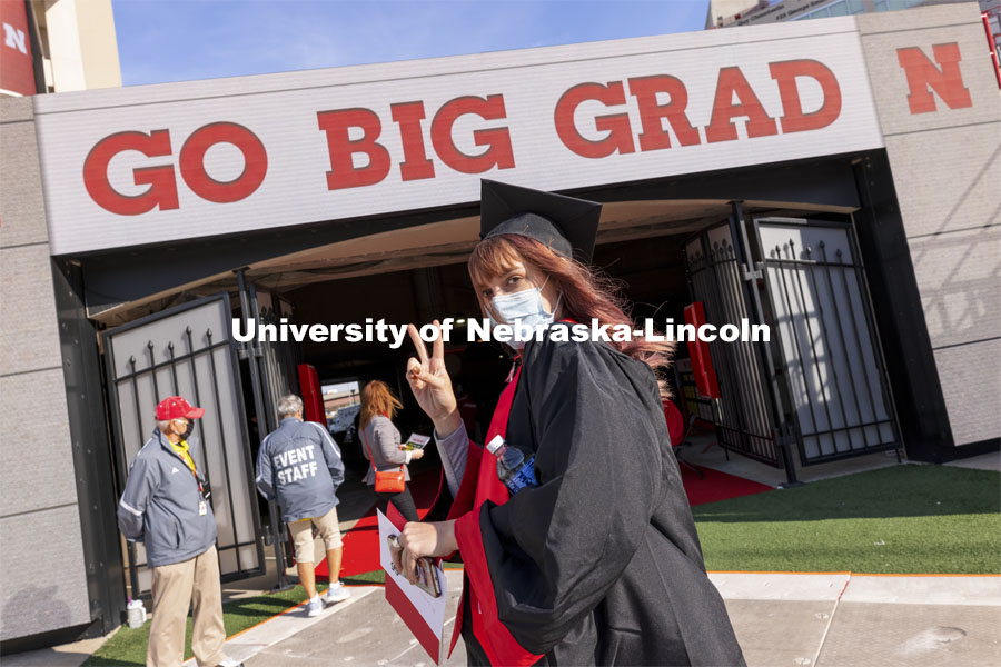 Macy Behrens flashes the peace sign at the UNL Commencement in Memorial Stadium. May 8, 2021. Photo by Craig Chandler / University Communication.