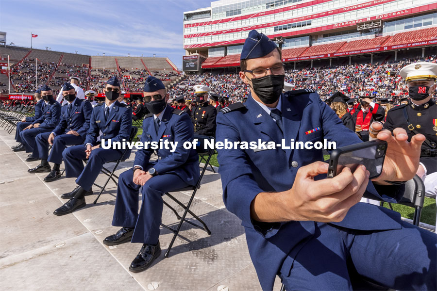 Air Force ROTC Cadet and engineering graduate Hunter Rausch takes a selfie of himself and fellow Air Force cadets before the start of the morning commencement. UNL Commencement in Memorial Stadium. May 8, 2021. Photo by Craig Chandler / University Communication.
