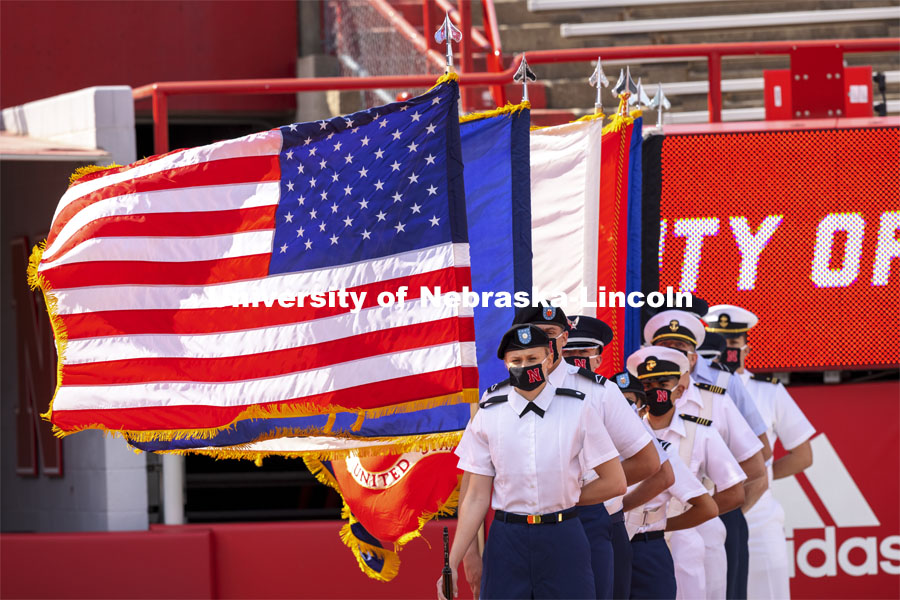 Flags stand at attention at the morning ceremony along with Cadet Sophie Byland and the ROTC Combined Units Color Guard. UNL Commencement in Memorial Stadium. May 8, 2021. Photo by Craig Chandler / University Communication.