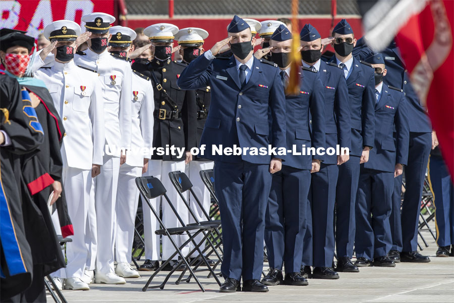 ROTC cadets salute the flag during the national anthem. UNL Commencement in Memorial Stadium. May 8, 2021. Photo by Craig Chandler / University Communication.
