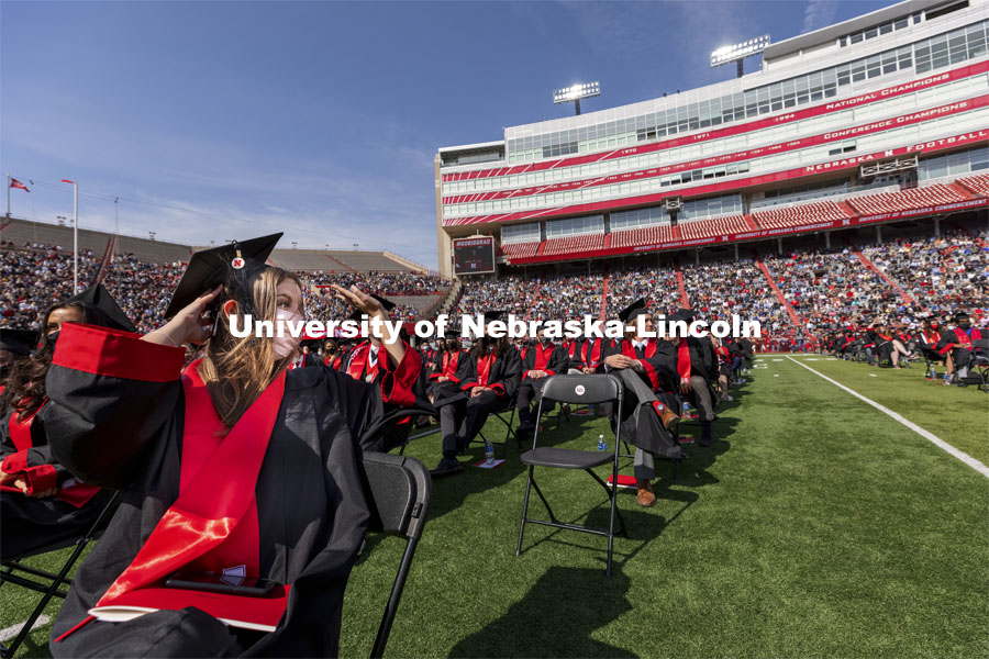 Maddalynne Armstrong waves to family and friends during the ceremony. UNL Commencement in Memorial Stadium. May 8, 2021. Photo by Craig Chandler / University Communication.