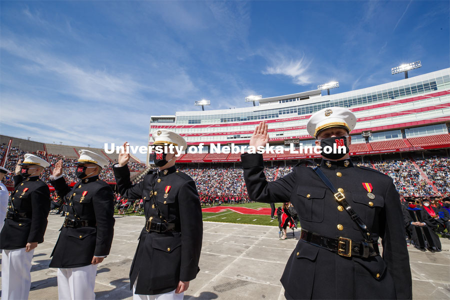 Marine ROTC cadets recite the oath of enlistment at the beginning of the second commencement. The cadets then changed into regalia to graduate with their colleges. The university conferred a record 3,594 degrees during the May commencement ceremonies. UNL Commencement in Memorial Stadium. May 8, 2021. Photo by Craig Chandler / University Communication.