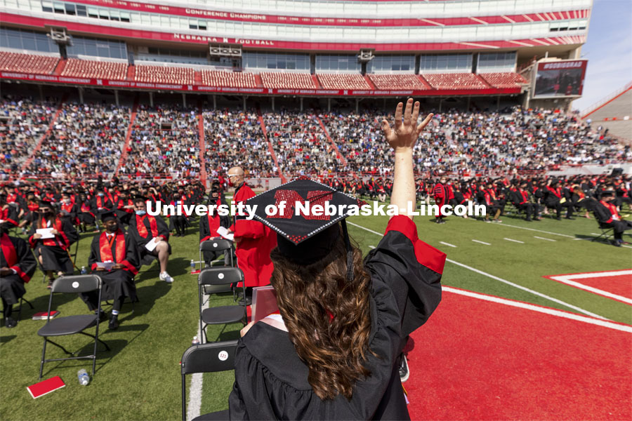 Karlie Sines waves to family and friends after receiving her Fine and Performing Arts degree. UNL Commencement in Memorial Stadium. May 8, 2021. Photo by Craig Chandler / University Communication.