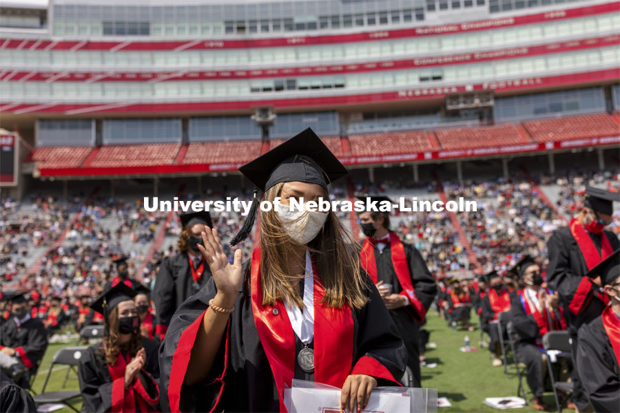 Destiney Chitrodom waves at the UNL Commencement in Memorial Stadium. May 8, 2021. Photo by Craig Chandler / University Communication.