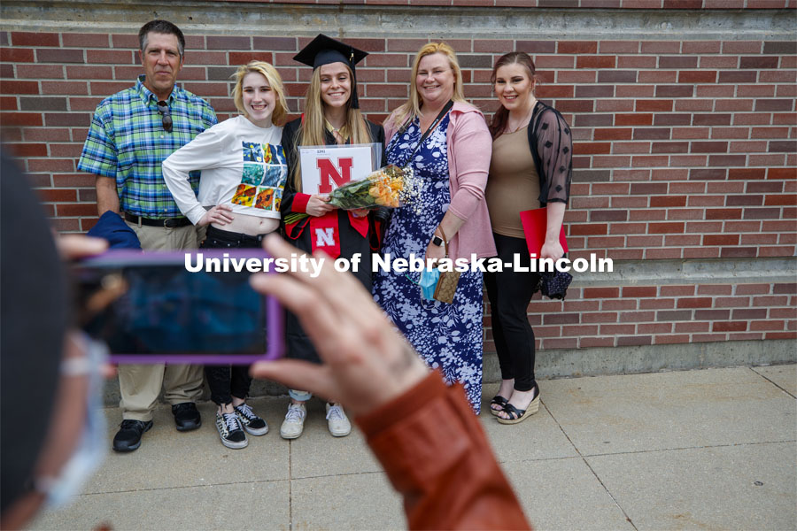 Brittany Stewart poses with family for a photo following the morning commencement. UNL Commencement in Memorial Stadium. May 8, 2021. Photo by Craig Chandler / University Communication.