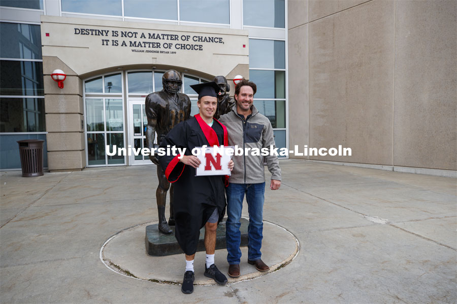 Luke Lauby and his cousin, Tracy, stand in front of the Tom Osborne and Brook Berringer statue outside of north stadium. UNL Commencement in Memorial Stadium. May 8, 2021. Photo by Craig Chandler / University Communication.