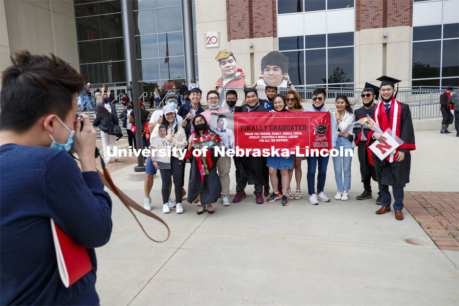 Frederick Chua poses with family and friends after the morning commencement. UNL Commencement in Memorial Stadium. May 8, 2021. Photo by Craig Chandler / University Communication.