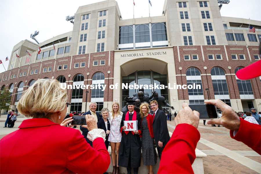 Daniel Pearson and family pose in front of Memorial Stadium following the morning commencement. UNL Commencement in Memorial Stadium. May 8, 2021. Photo by Craig Chandler / University Communication.