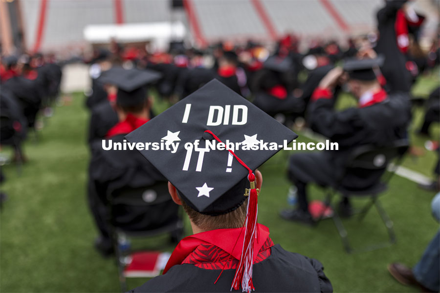 Grad wearing a decorated mortar board that says, “I DID IT!”. The university conferred a record 3,594 degrees during the May commencement ceremonies. UNL Commencement in Memorial Stadium. May 8, 2021. Photo by Craig Chandler / University Communication.