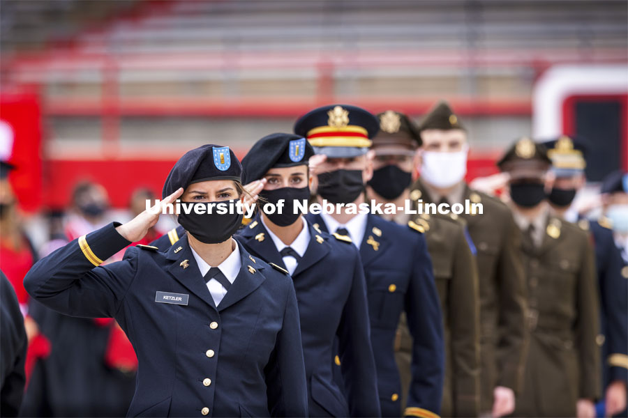 New Army Second Lieutenants including Alex Ketzler salute the color guard at the beginning of the second commencement. The former ROTC cadets then recited the Oath and Enlistment and then changed into regalia to graduate with their colleges. The university conferred a record 3,594 degrees during the May commencement ceremonies. UNL Commencement in Memorial Stadium. May 8, 2021. Photo by Craig Chandler / University Communication.