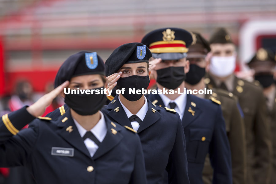 New Army Second Lieutenants including Taylor Butalla salute the color guard at the beginning of the second commencement. The former ROTC cadets then recited the Oath and Enlistment and then changed into regalia to graduate with their colleges. The university conferred a record 3,594 degrees during the May commencement ceremonies. UNL Commencement in Memorial Stadium. May 8, 2021. Photo by Craig Chandler / University Communication.