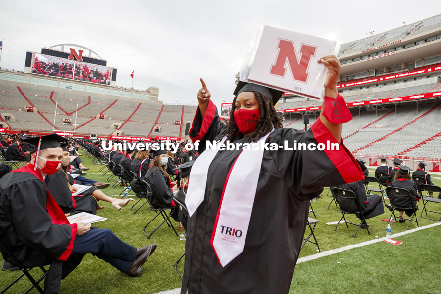 Vanessa Reiser gestures to her family and friends in the stadium after receiving her biological sciences degree. The university conferred a record 3,594 degrees during the May commencement ceremonies. UNL Commencement in Memorial Stadium. May 8, 2021. Photo by Craig Chandler / University Communication.