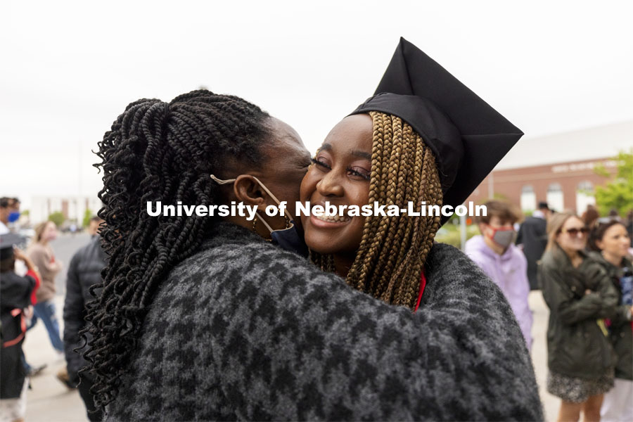 Amblessed Kanu-Asiegbu hugs family outside Memorial Stadium following the second ceremony. The university conferred a record 3,594 degrees during the May commencement ceremonies. UNL Commencement in Memorial Stadium. May 8, 2021. Photo by Craig Chandler / University Communication. 