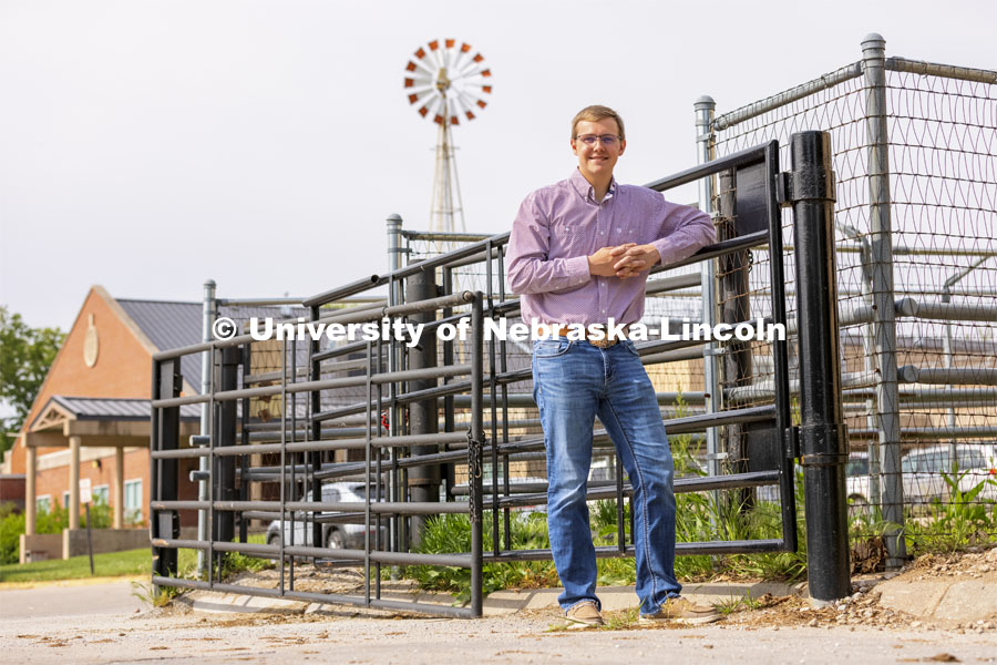 Bryar Gerlach, a senior animal science major, poses by a corral for an ASEM recruitment feature story. May 11, 2021. Photo by Craig Chandler / University Communication.    