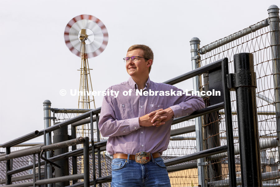 Bryar Gerlach, a senior animal science major, poses by a corral for an ASEM recruitment feature story. May 11, 2021. Photo by Craig Chandler / University Communication.    