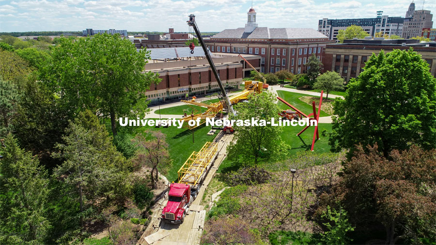 A large crane is being assembled west of Love Library. A summer project will close Love Library North, Adele Hall Learning Commons and the Love Library Link starting May 7. The project will remove deteriorating decorative structures — massive precast concrete panels and metal screens — that adorn the roofline of Love North. May 12, 2021. Photo by Craig Chandler / University Communication.