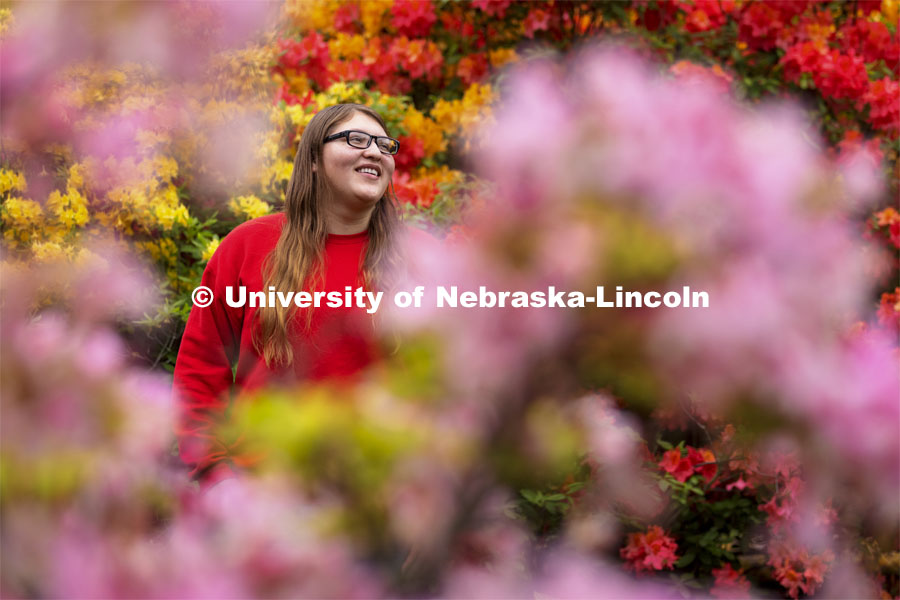 Daelyn Zagurski, a senior fisheries and wildlife major, poses amongst the azaleas on East Campus for ASEM recruitment story. May18, 2021. Photo by Craig Chandler / University Communication.