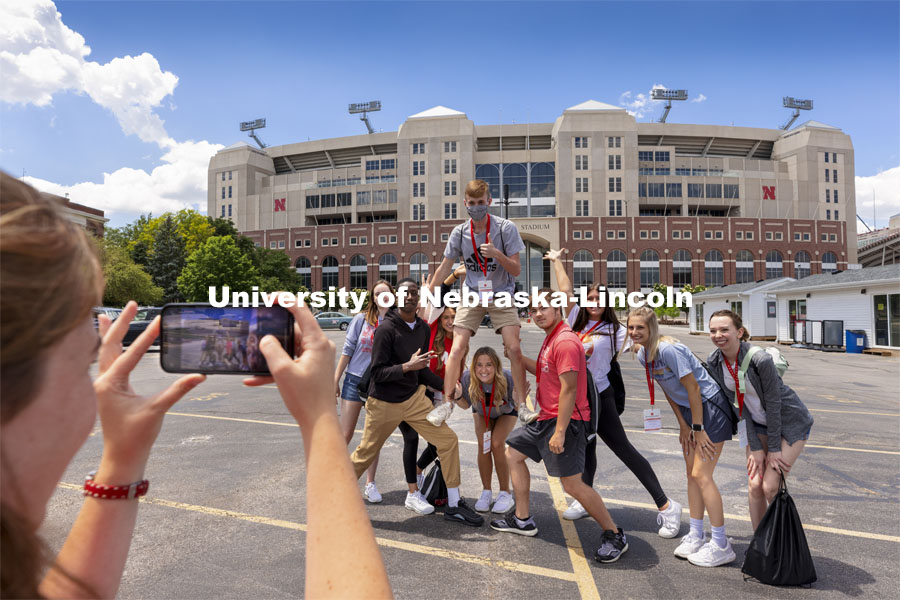 NSE Orientation Leader Gracie Williams takes her group’s photo outside of Memorial Stadium as they walk through campus. New Student Enrollment began this week and will continue through July 9. June 2, 2021. Photo by Craig Chandler / University Communication.
