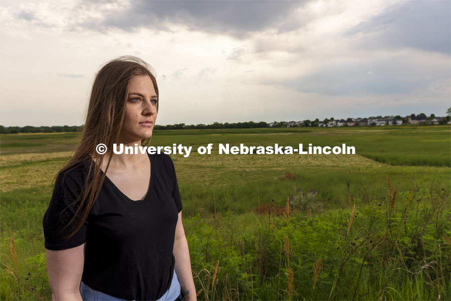 Nicole Fiore, a graduate student in biological sciences, is studying methanogens, a type of methane-producing microorganism, that lives in the wetlands in north Lincoln and could possibly live on Mars. Fiore is pictured by the wetlands behind Cracker Barrel on North 27th Street. June 24, 2021. Photo by Craig Chandler / University Communication.