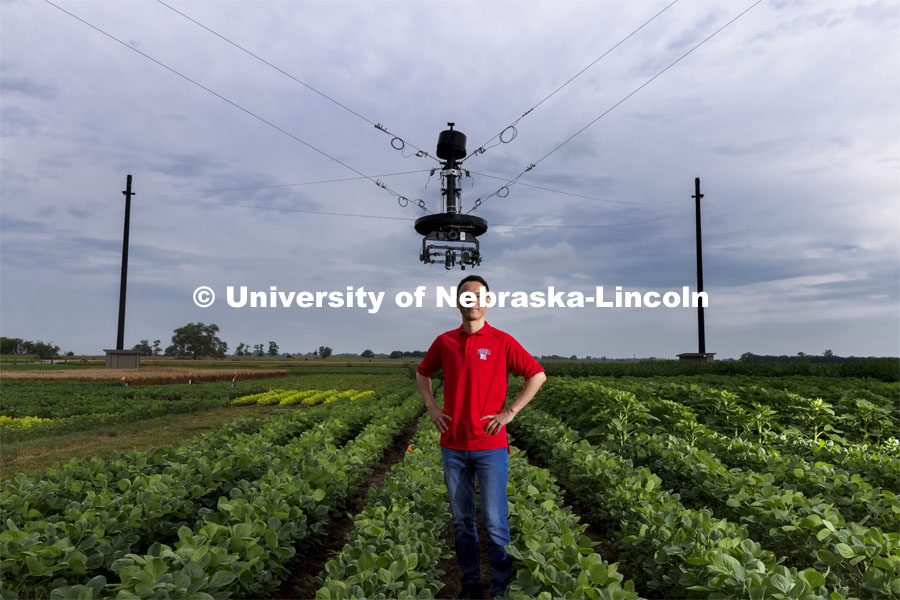 Yufeng Ge, Associate Professor of Biological Systems Engineering, is advancing high-tech plant phenotyping to study plant’s physical traits, leading to improved yields, drought resistance. He is photographed in the spider cam field near Mead, Nebraska. July 8, 2021. Photo by Craig Chandler / University Communication.