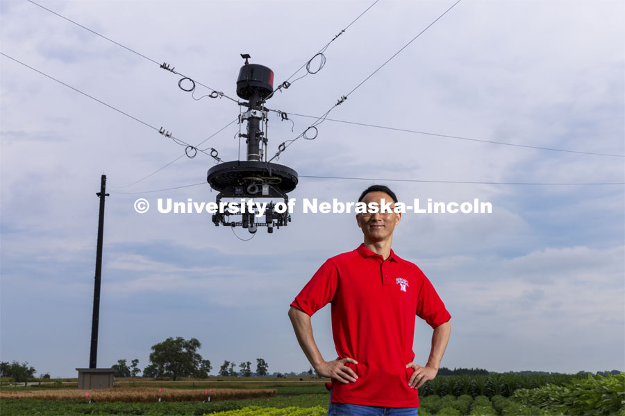 Yufeng Ge, Associate Professor of Biological Systems Engineering, is advancing high-tech plant phenotyping to study plant’s physical traits, leading to improved yields, drought resistance. He is photographed in the spider cam field near Mead, Nebraska. July 8, 2021. Photo by Craig Chandler / University Communication.